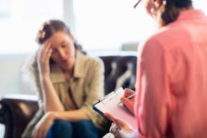 a person in a residential treatment program talks to a therapist