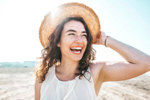 a person on the beach smiles after starting rehab admissions