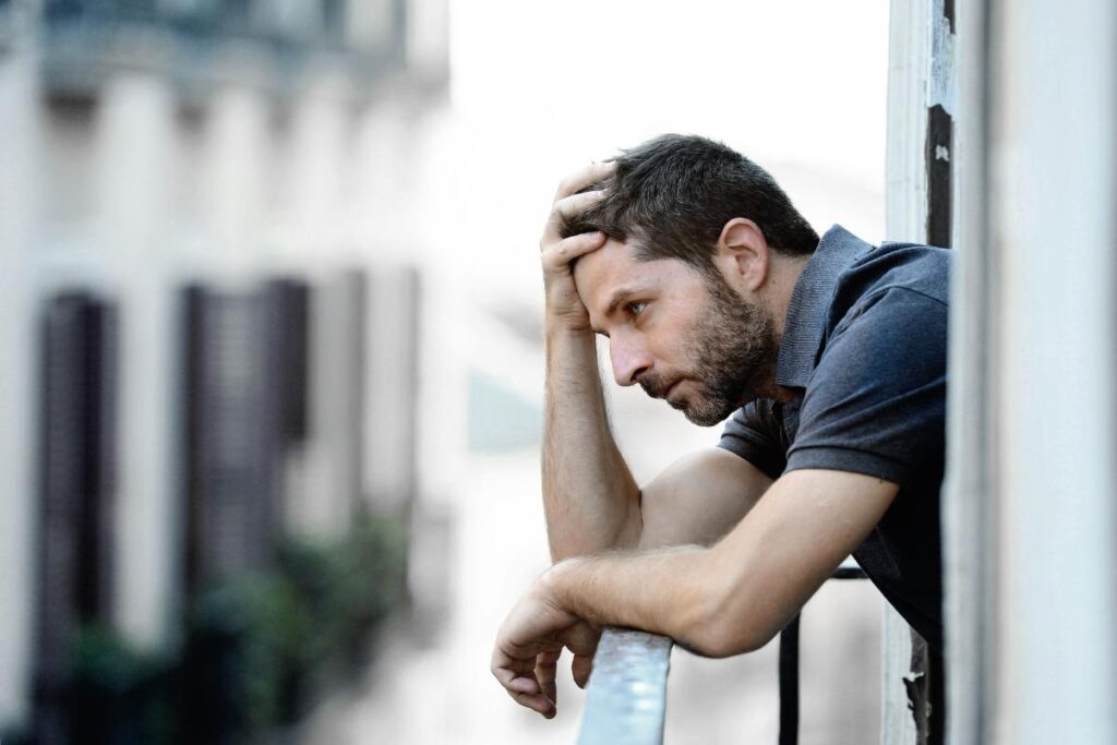 a person leans on a balcony pondering common co-occurring disorders