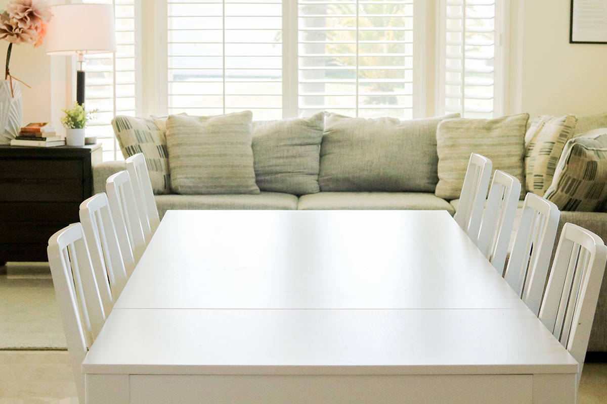 a dining table in front of a couch