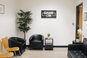 a lobby area with a sign on the wall reading "Game On"