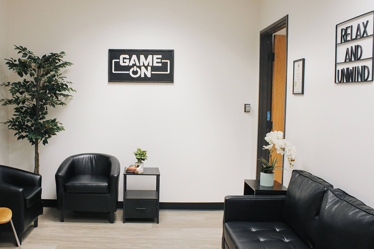 signs reading "Game On" and "Relax and Unwind" in a lobby area
